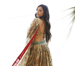 Srinidhi Shetty in an embroidered beige lehenga with a red dupatta against a bright white background HD wallpaper