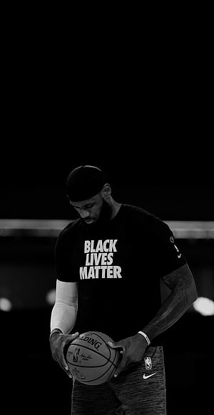 LeBron James in Black Lives Matter shirt holding basketball in monochrome HD phone wallpaper
