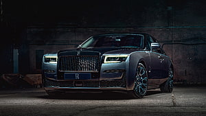 Rolls Royce Ghost luxury sedan in dark industrial setting with illuminated headlights HD wallpaper