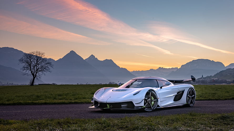 Koenigsegg Jesko Supercar Parked on a Country Road at Sunset with Mountain Silhouettes HD wallpaper