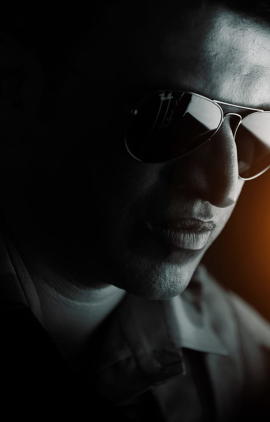 Puneeth Rajkumar in Dramatic Low-Key Portrait Wearing Aviator Sunglasses HD phone wallpaper