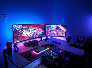 Vibrant RGB Gaming Desk Setup With Dual Monitors And Custom PC Build HD wallpaper