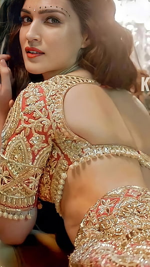 Kriti Sanon in an ornate red and gold embroidered lehenga with intricate zari work HD phone wallpaper