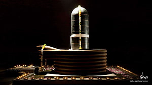 Isha Dhyanalinga Sacred Stone Sculpture Illuminated by Candles and Floral Offerings HD wallpaper