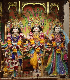 Lord Rama, Sita, and Lakshmana Darbar with Elaborate Floral Garlands and Ornate Temple Decor HD phone wallpaper