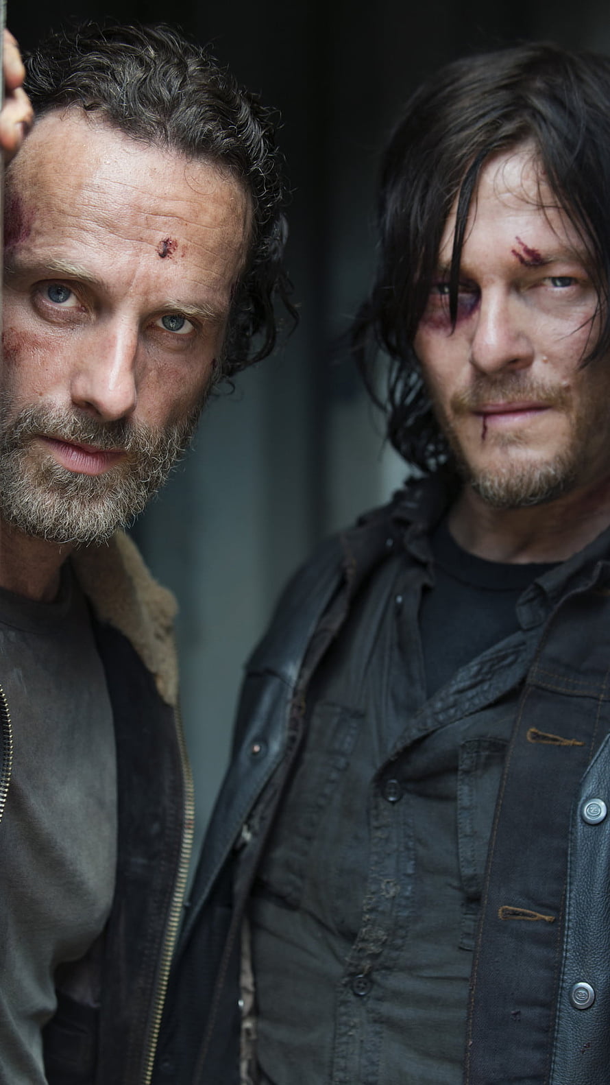 Rick and Daryl from The Walking Dead in a gritty close-up portrait with battle-worn expressions HD phone wallpaper