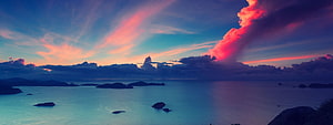 Vivid Sunset Over Calm Sea With Dramatic Pink Clouds and Distant Islands HD wallpaper