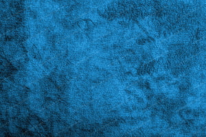 Deep Blue Velvet Texture with Soft Fabric Grain and Subtle Dark Mottling HD wallpaper