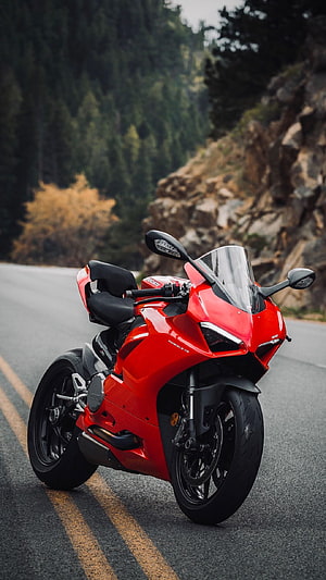 Red Ducati Panigale V4 Superbike Parked on a Winding Mountain Road HD phone wallpaper