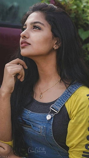 Mamitha Baiju in Denim Overalls and Yellow Top with Gold Necklace HD phone wallpaper