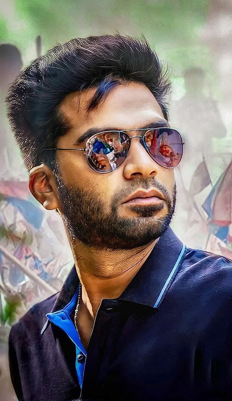 Simbu in Maanaadu wearing reflective aviator sunglasses and a dark collared shirt HD phone wallpaper