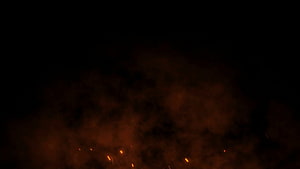 Glowing orange embers and smoke rising against a dark night sky HD wallpaper
