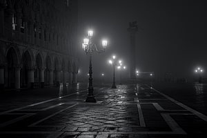 Atmospheric Black and White Foggy Night Scene with Ornate Street Lamps and Gothic Architecture HD wallpaper