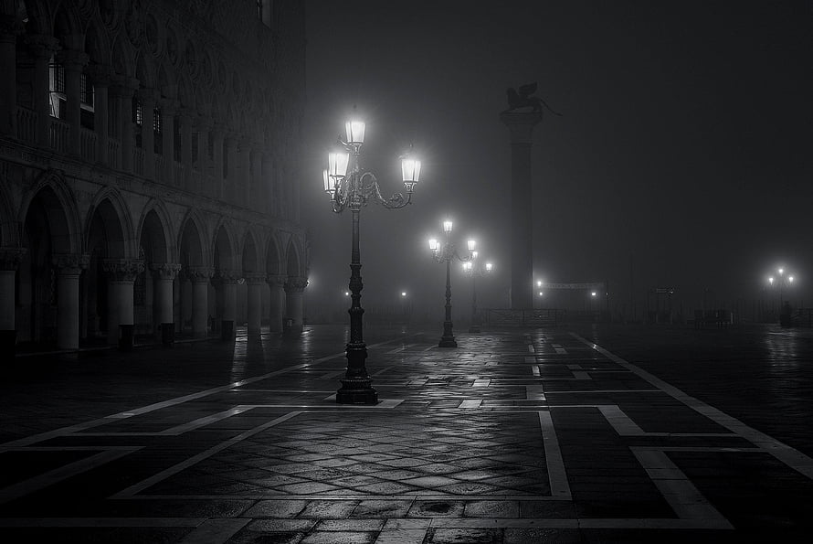 Atmospheric Black and White Foggy Night Scene with Ornate Street Lamps and Gothic Architecture HD wallpaper