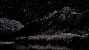 Monochrome Night Landscape with Snow-Capped Mountains and Starry Sky Over a Calm Lake HD wallpaper