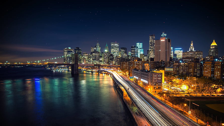 New York City Skyline at Night with Brooklyn Bridge and East River Light Trails HD wallpaper
