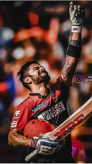 Virat Kohli Celebrating Victory in RCB Jersey with Cricket Bat and Helmet HD phone wallpaper