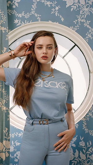 Katherine Langford in Light Blue Eresake Outfit with Floral Wallpaper Background HD phone wallpaper
