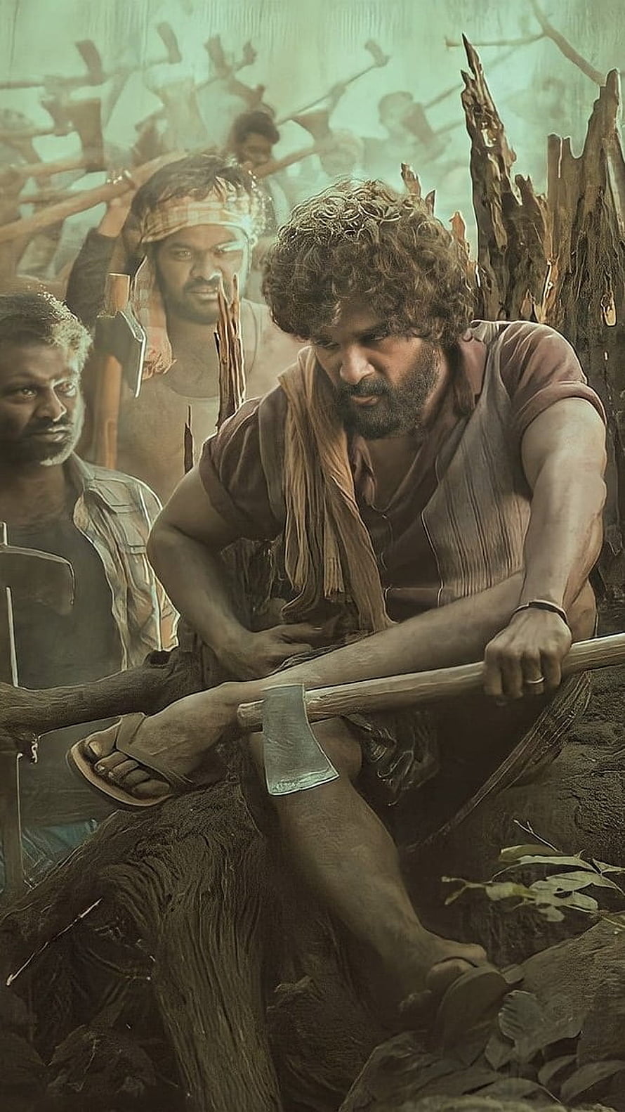 Allu Arjun as Pushpa Raj sharpening an axe in a gritty forest setting HD phone wallpaper