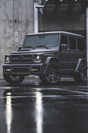 Matte Black Mercedes-Benz G-Class SUV with Custom Wheels on Wet Concrete HD phone wallpaper