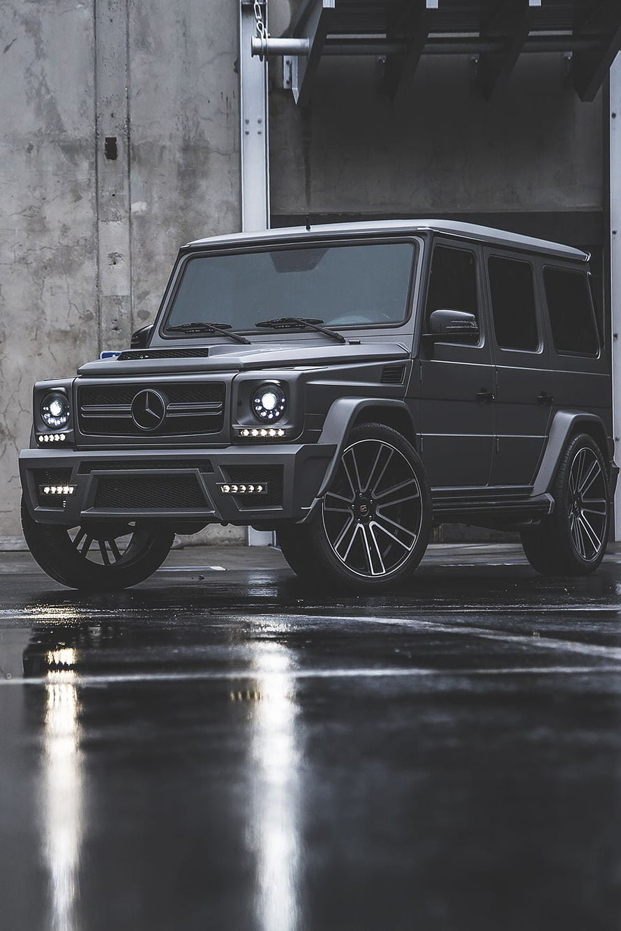 Matte Black Mercedes-Benz G-Class SUV with Custom Wheels on Wet Concrete HD phone wallpaper