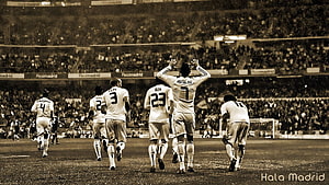 Real Madrid players celebrating on the pitch at the Santiago Bernabéu stadium HD wallpaper