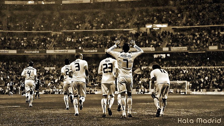 Real Madrid players celebrating on the pitch at the Santiago Bernabéu stadium HD wallpaper