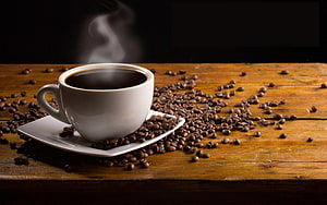 Steaming White Coffee Cup on Rustic Wooden Table Surrounded by Roasted Beans HD wallpaper