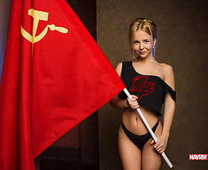Blonde model posing with a red Soviet flag featuring hammer and sickle emblem HD wallpaper