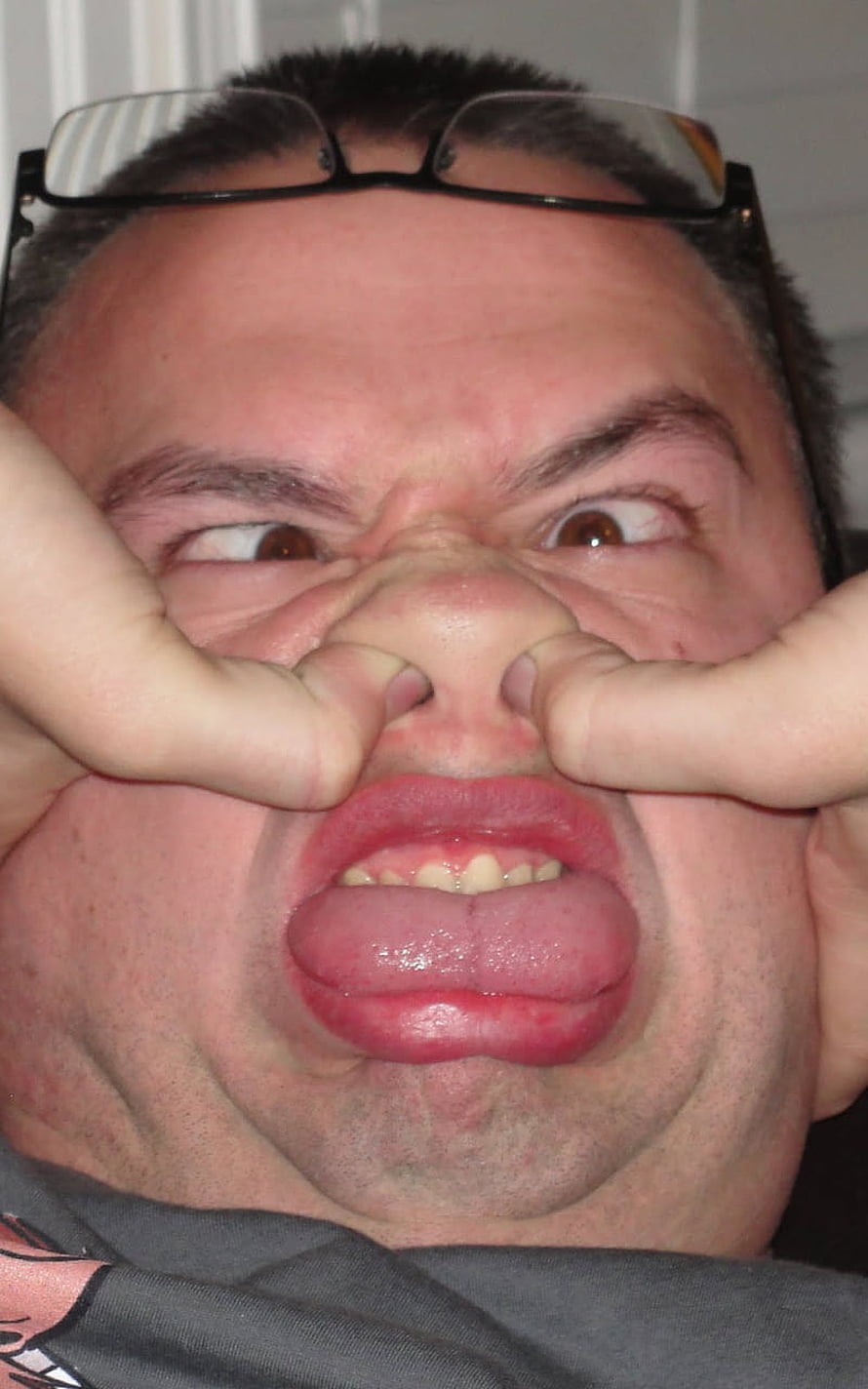 Funny Man Making Silly Face With Fingers Pinching Nose and Sticking Out Tongue HD phone wallpaper
