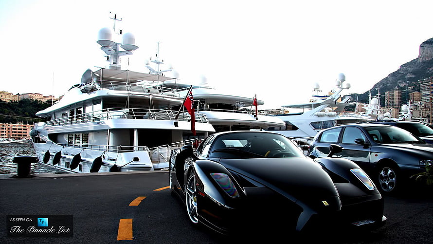 Black Ferrari Enzo Parked at Monaco Marina with Luxury Superyachts HD wallpaper