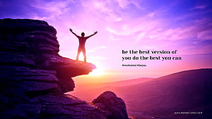 Silhouette of a person standing on a rocky cliff with arms raised against a vibrant purple and pink sunset sky HD wallpaper