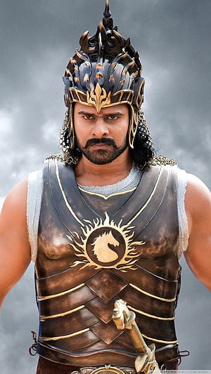 Prabhas as Baahubali in ornate warrior armor and crown from the epic Indian film HD phone wallpaper