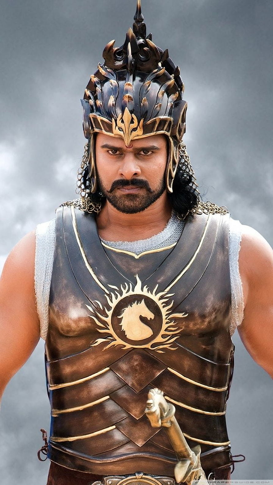 Prabhas as Baahubali in ornate warrior armor and crown from the epic Indian film HD phone wallpaper