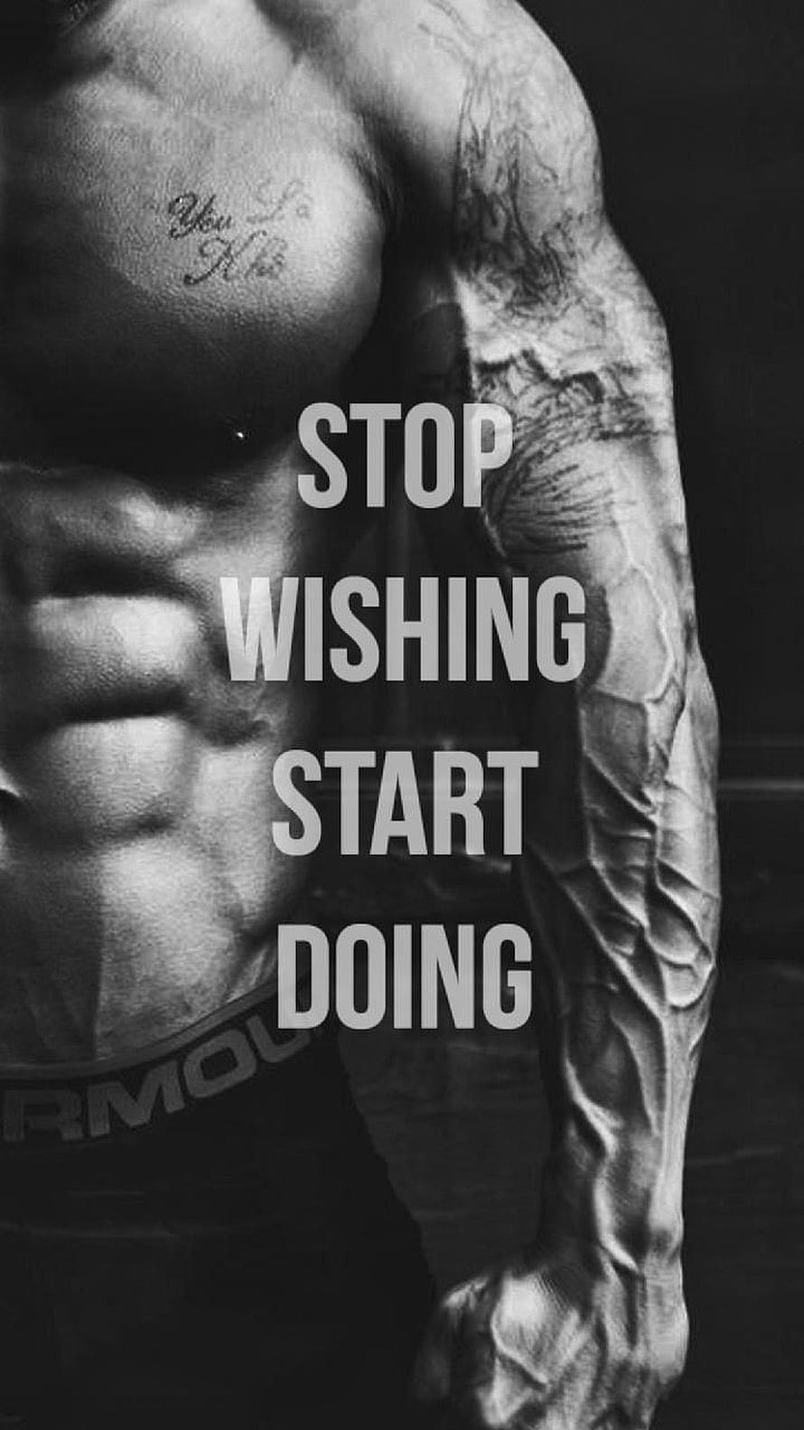 Black and white photo of a muscular man with tattoos and a motivational quote about action HD phone wallpaper