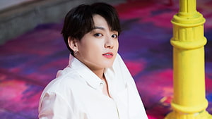 Jungkook in White Shirt Against Vibrant Pink and Purple Background HD wallpaper