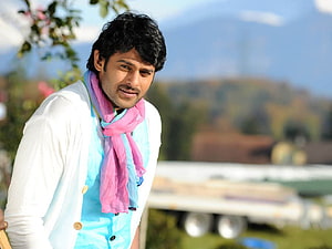 Prabhas in White Jacket and Pink Scarf with Outdoor Scenic Background HD wallpaper
