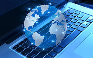Glowing Digital Globe with Network Connections Hovering Over a Modern Laptop Keyboard HD wallpaper