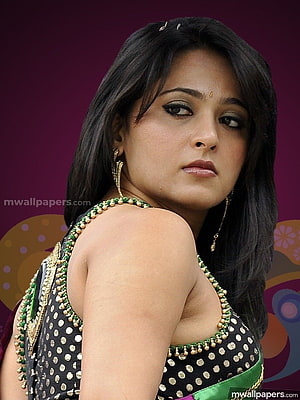 Anushka Shetty in Black Polka Dot Blouse with Green and Gold Beaded Trim HD phone wallpaper