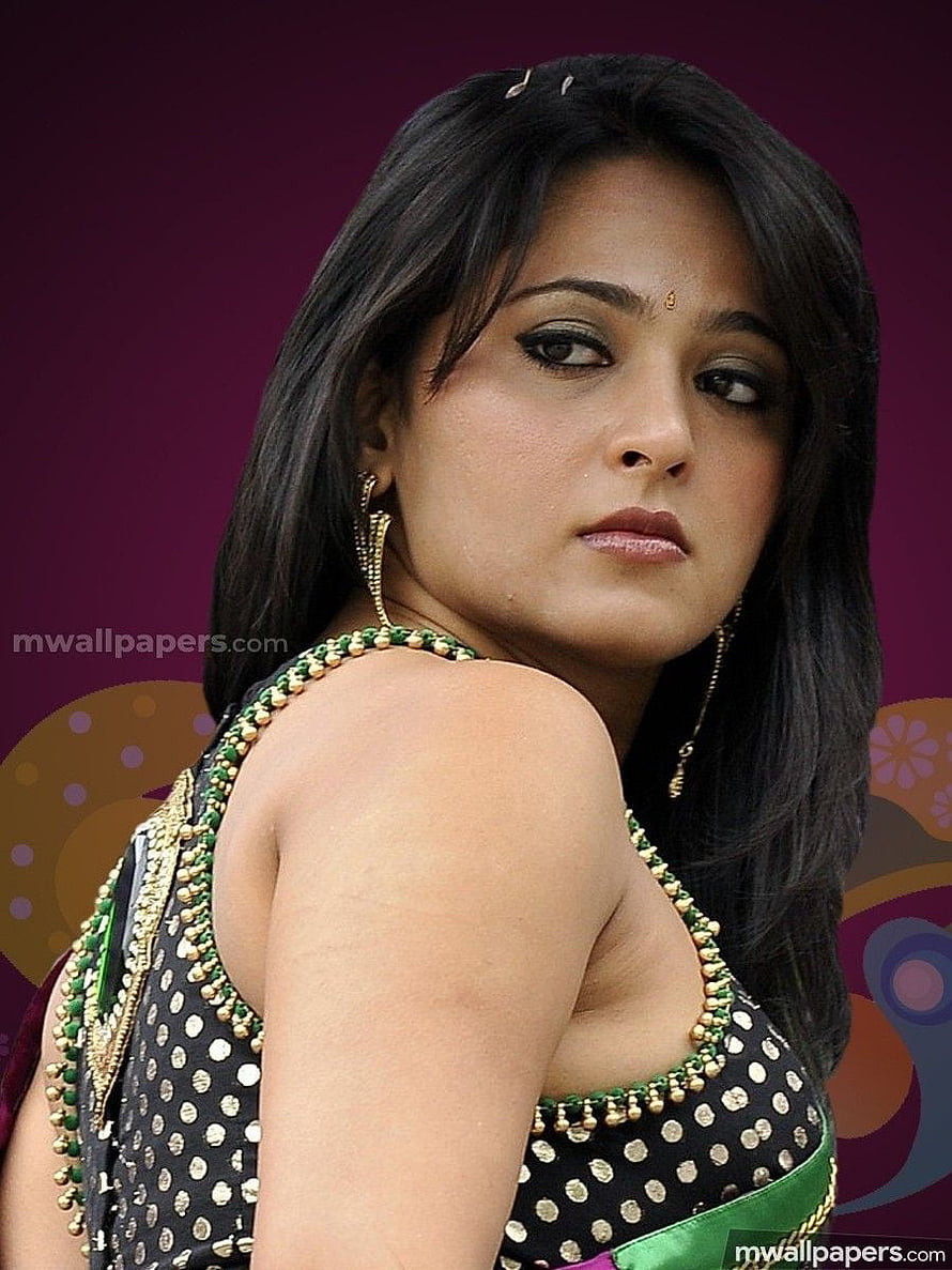 Anushka Shetty in Black Polka Dot Blouse with Green and Gold Beaded Trim HD phone wallpaper