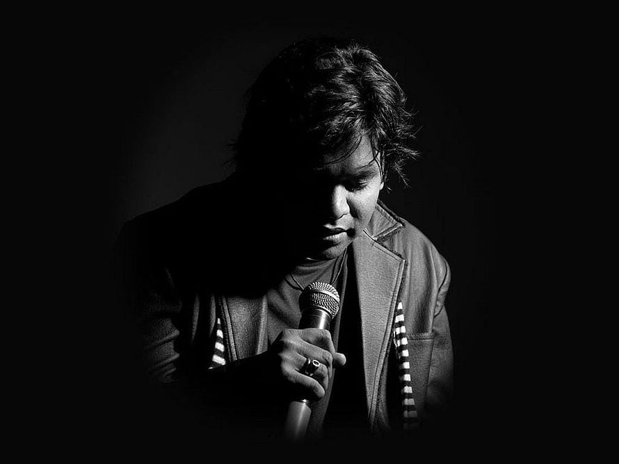 A. R. Rahman Black and White Portrait Holding Microphone in Dramatic Low-Key Lighting HD wallpaper
