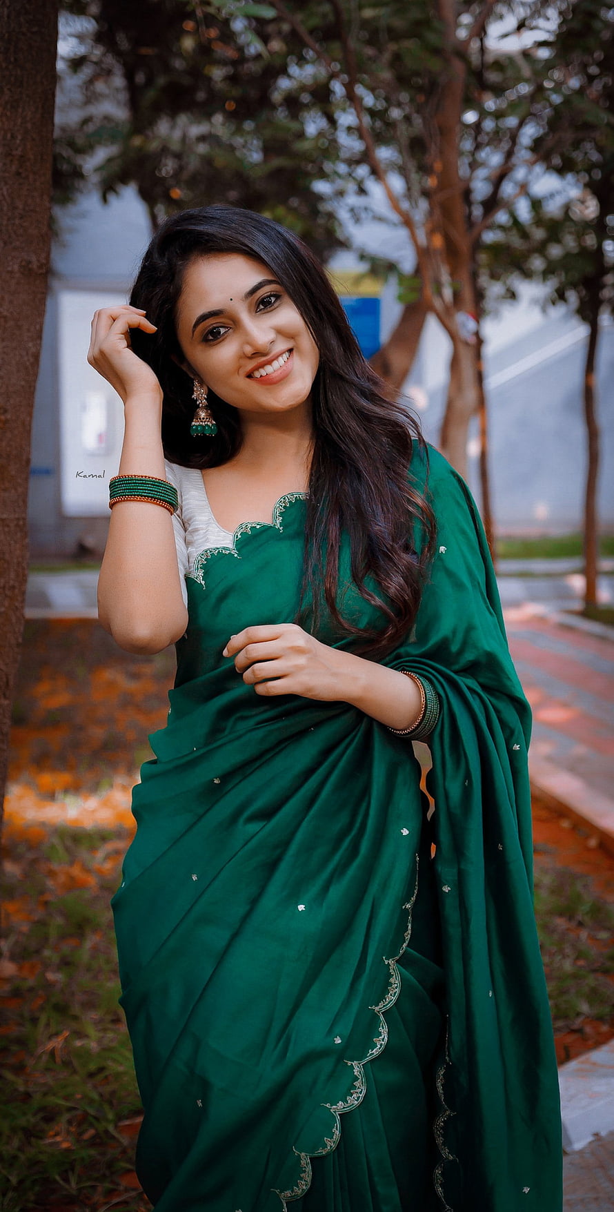 Priyanka Mohan in an elegant emerald green saree with gold embroidery and traditional jewelry HD phone wallpaper