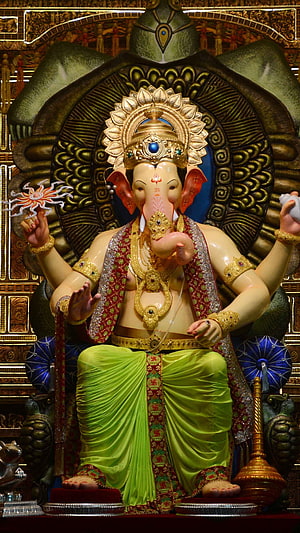 Lalbaugcha Raja Ganesh Murti with Golden Crown and Green Dhoti in Temple Setting HD phone wallpaper