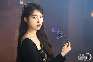 IU as Go Moon Young in Hotel Del Luna holding a blue flower HD wallpaper
