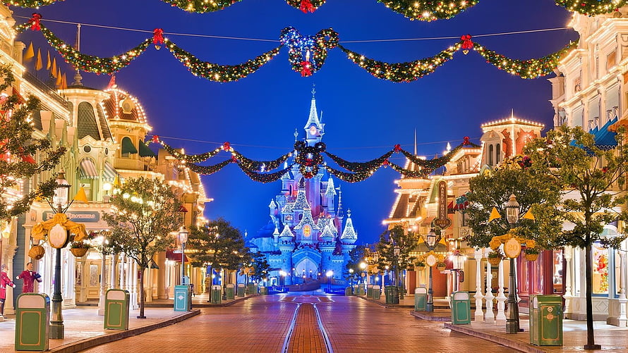 Walt Disney World Christmas Night Scene with Illuminated Castle and Holiday Decorations HD wallpaper