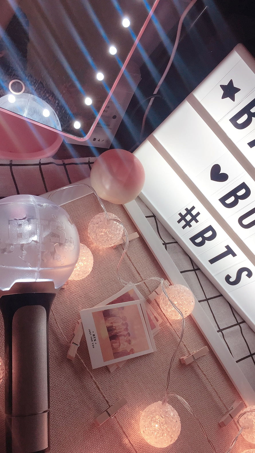 BTS Lightstick and Fan Decor Setup with Warm Fairy Lights and Polaroid Photos HD phone wallpaper