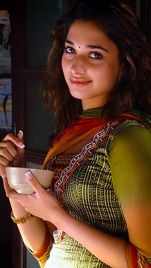 Tamanna Bhatia in Traditional Green and Orange Ethnic Wear Holding a Bowl HD phone wallpaper