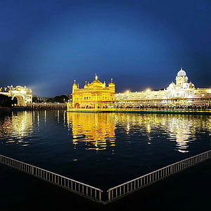 Golden Temple at Night in Amritsar with Reflections on the Sacred Pool HD phone wallpaper