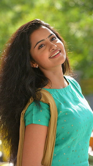 Anupama Parameswaran in a teal kurta with mustard dupatta against a green bokeh background HD phone wallpaper