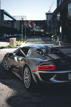 Porsche 918 Spyder Rear Three-Quarter View Parked on Urban Cobblestone Street HD phone wallpaper